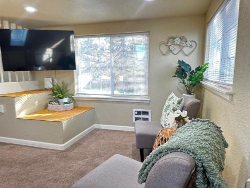a living room with a flat screen tv and a couch at Near Downtown- Kitchen-washerdryer-parking in Medford