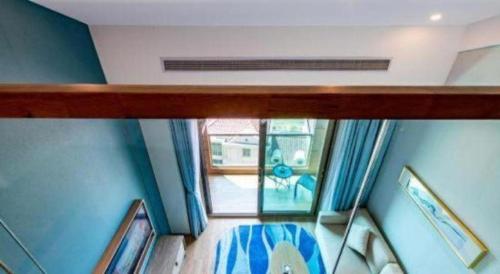 a view from the top of a room with blue walls at Emerald Bay Hotel in Yuxi