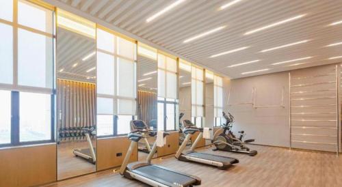 a gym with a row of exercise bikes in a room at Wanda JIN Baise in Baise