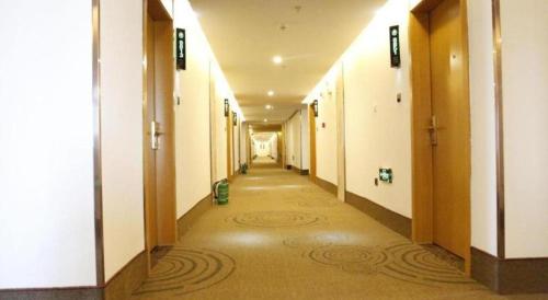 a hallway of a building with a long corridor at GreenTree Inn Ordos Kangbashi District Ulan Mulun Street Branch in Ordos