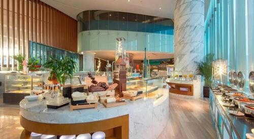 a lobby of a building with a dessert counter at Fliport Hotel Zhangzhou Yuanshan in Zhangzhou