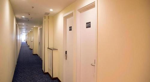 a row of white doors in a hallway at 7 Days Inn Xi'an North Economic Development Zone 4th Fengcheng Road in Xi'an