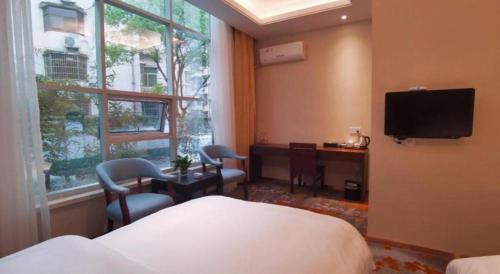 Uma TV ou centro de entretenimento em Huangshan Shuguang Yusong Hotel
