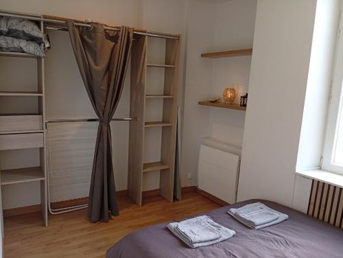 a bedroom with a bed and a closet with shelves at Aux portes de l'Eure in Bonnières-sur-Seine