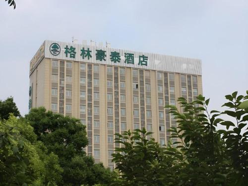 a building with a sign on the top of it at GreenTree Inn Shanghai Jiading Newtown MaLu Subway Station Business Hotel in Jiading