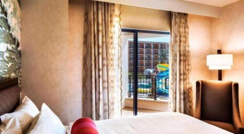 a hotel room with a bed and a window at Courtyard by Marriott Anaheim Theme Park Entrance in Anaheim