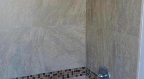 a shower with a glass door in a bathroom at Las Palmas Hotel in Los Angeles
