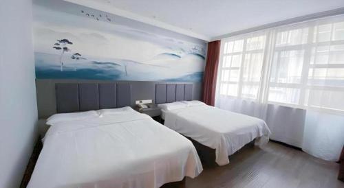 Ένα ή περισσότερα κρεβάτια σε δωμάτιο στο GreenTree Inn HanZhong Railway Station Beiyihuan Road Express Hotel