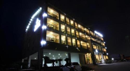 a large building with lights on it at night at Sea View Hotel in Jeju