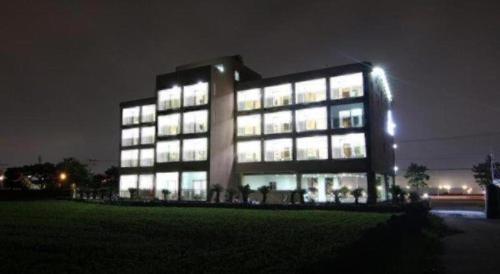a large building with many windows at night at Sea View Hotel in Jeju