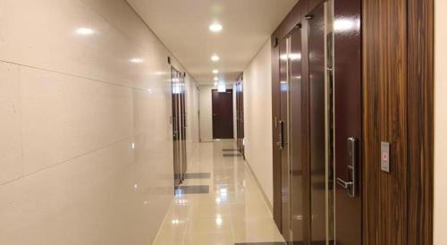 a hallway of a building with glass doors and a hallway at Sea View Hotel in Jeju