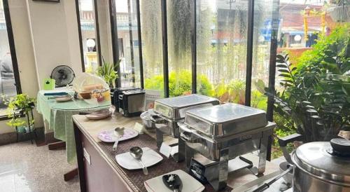 a kitchen with a bunch of food on a counter at Ritzy House Hotel in Chumphon