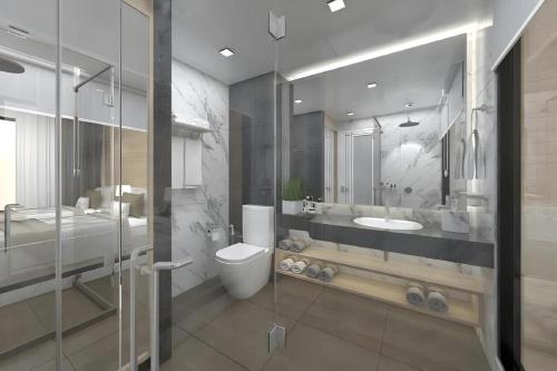 a bathroom with a toilet and a sink at Thaisun Bangkok Hotel in Bangkok