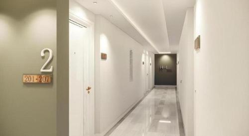 a hallway with white walls and a number on the wall at Thaisun Bangkok Hotel in Bangkok