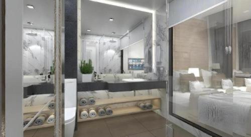 a large bathroom with a tub and a large mirror at Thaisun Bangkok Hotel in Bangkok