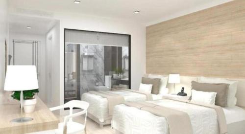 a white bedroom with two beds and a couch at Thaisun Bangkok Hotel in Bangkok