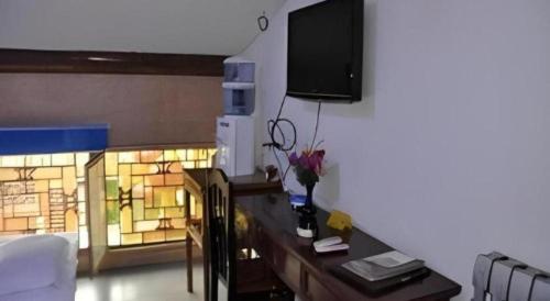Una televisión o centro de entretenimiento en Pingyao Yufengheng Hotel