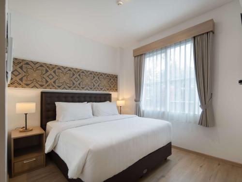 Ένα ή περισσότερα κρεβάτια σε δωμάτιο στο Cove Bening Boutique