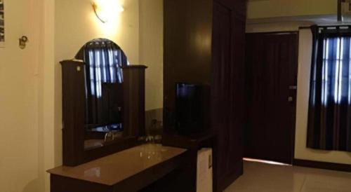 a bathroom with a sink and a mirror at Senesouk Hotel in Vientiane