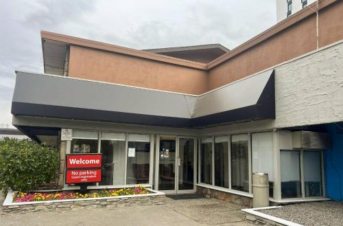 a welcome sign in front of a building at Econo Lodge Motel Village in Calgary