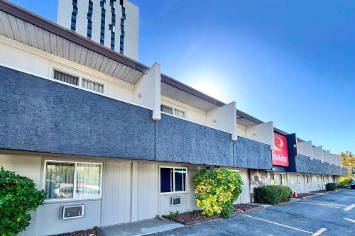 a building with a blue wall and a parking lot at Econo Lodge Motel Village in Calgary