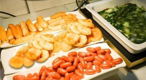 a table topped with different types of fruits and vegetables at City Comfort Inn Wuhan High Speed Railway Station in Wuhan