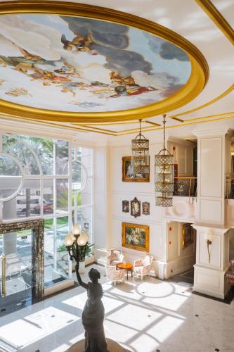 a living room with a painting on the ceiling at The IMPERIAL Vung Tau Hotel in Vung Tau