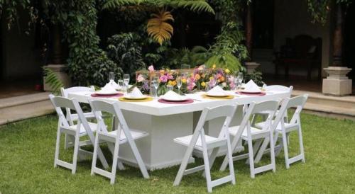 a white table with white chairs and flowers on it at Hotel Casa Suwon in Suwon