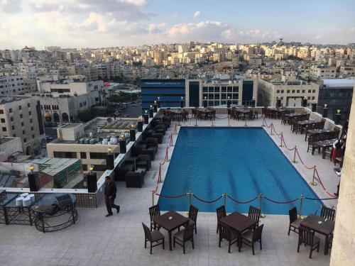 a swimming pool on the roof of a building at Arena Space Hotel in Amman