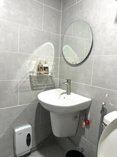 a bathroom with a sink and a mirror at Athenas Cozy Place in Mandaue City