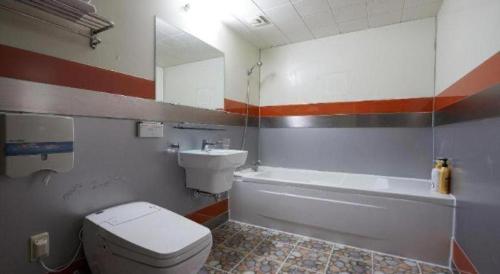 a bathroom with a white toilet and a sink at Hotel Head-One in Uijeongbu