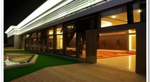 a large building with windows and a green floor at Putian Haiyuan International Hotel in Putian