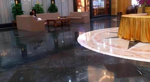 a lobby with a table and chairs in a building at Golden Lustre Hotel in Shenzhen