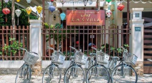 a group of bikes parked in front of a gate at Kim's Villa Hoi An in Hoi An