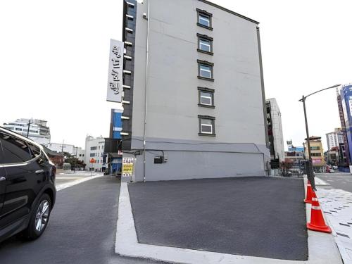 a car parked in a parking lot next to a building at Chuncheon World Hotel in Chuncheon