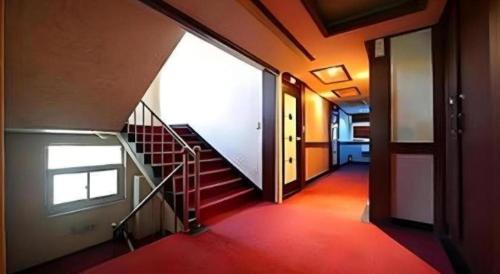 a hallway with a spiral staircase in a building at Chuncheon World Hotel in Chuncheon