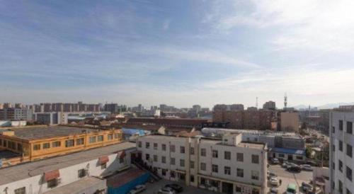 an aerial view of a city with buildings at Vienna Classic Hotel Qingdao Huangdao in Huangdao