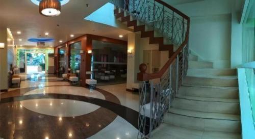 a spiral staircase in a building with a lobby at Hotel Camila 2 in Dipolog