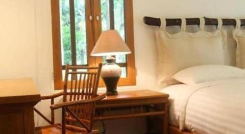 Postel nebo postele na pokoji v ubytování Chiangkham Luang Resort