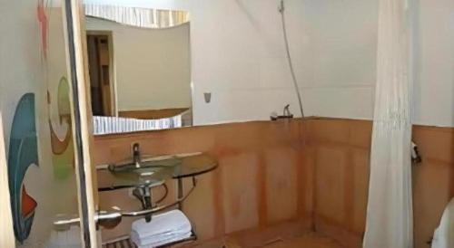 a bathroom with a sink and a mirror at Hotel Formosa in Manado