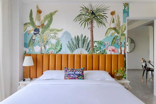 a bedroom with a large bed with a orange headboard at Happy Home by Leo Homes - 2BHK Flat in Candolim in Candolim