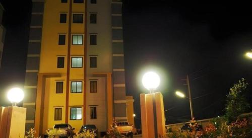 two street lights in front of a building at night at Regent Room Hotel in Suratthani