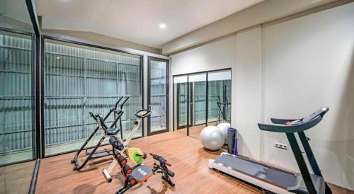 a gym with a exercise bike and a treadmill at Lotus Hotel Subang in Bandung