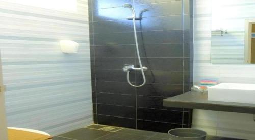 a bathroom with a shower and a sink at Lotus Hotel Subang in Bandung