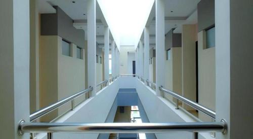 an empty hallway of a building with a long aisle at Lotus Hotel Subang in Bandung
