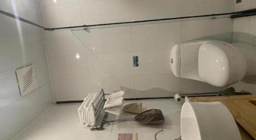 a bathroom with a sink and a phone on the floor at Beijing Inner Mongolia Hotel Chaoyang in Beijing
