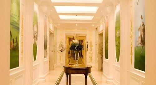 a hallway with a vase of flowers on a table at Beijing Inner Mongolia Hotel Chaoyang in Beijing