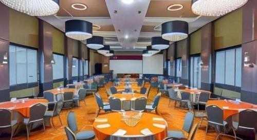 a large room with tables and chairs in it at The Oxalis Regency Hotel in Magelang