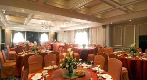 a large banquet hall with tables and chairs at Chinflux Mandarin Hotel in Dongguan