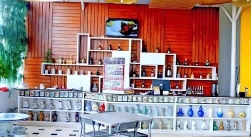 a room with a table and a counter with vases at Grant Hotel Subang in Bandung